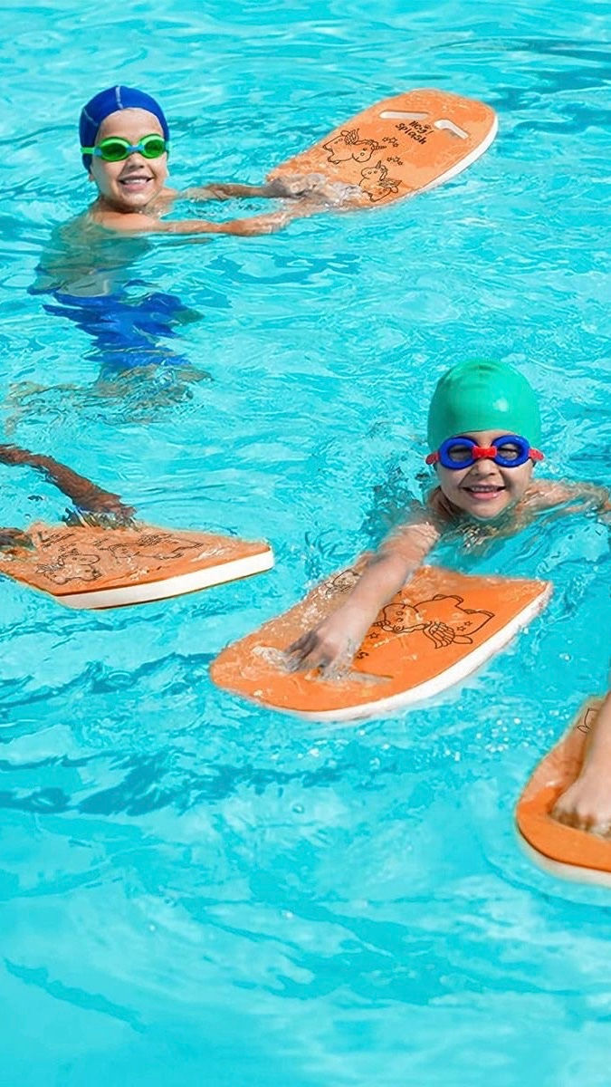 Coach teaching a child to swim in an outdoor pool